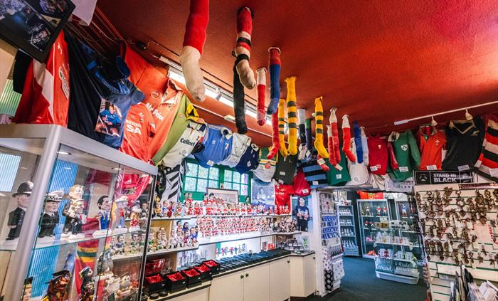 The photo shows a wide shot of the shop, with rugby socks hanging from the ceiling.